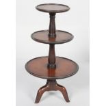 A mahogany George III style miniature three tier dumb waiter, with moulded rims,