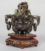 A Chinese carved mottled jade censer with cover and hardwood stand, 20th century, of mottled grey,