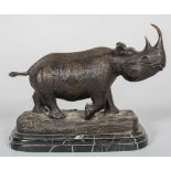 A patinated bronze sculpture of a rhinoceros,