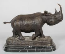 A patinated bronze sculpture of a rhinoceros,