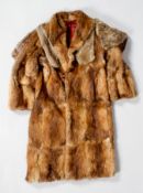 A vintage mink coat, of mud brown colour, with ark red satin lining and a rabbit cape with tie,