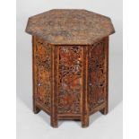 A carved Asian or Middle Eastern octagonal occasional table, carved with fruiting vine,