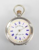 A silver open face pocket watch.