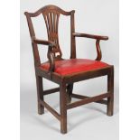 A George III oak carved dining chair, with scroll top rail and pierced vase shaped splat,