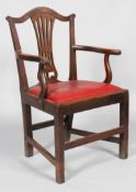 A George III oak carved dining chair, with scroll top rail and pierced vase shaped splat,