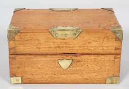 A brass bound mahogany box containing three glass bottles,