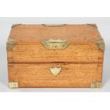 A brass bound mahogany box containing three glass bottles,