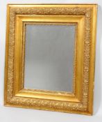 A late 19th century carved gilt and gesso rectangular wall mirror, later mirror plate,