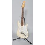 An Encore electric guitar, ivory coloured with soft travelling case,