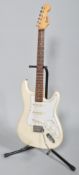 An Encore electric guitar, ivory coloured with soft travelling case,