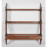 A late 20th century George III style mahogany hanging wall shelf,