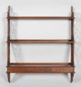 A late 20th century George III style mahogany hanging wall shelf,