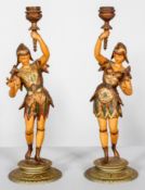 A pair of late 19th century continental cold painted spelter candlesticks, modelled on jesters,
