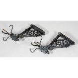 A pair of Edwardian cast iron wall lights, each with acanthus scroll brackets,