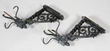 A pair of Edwardian cast iron wall lights, each with acanthus scroll brackets,