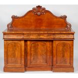 A Victorian mid 19th century mahogany sideboard with foliate carved waved gallery above two short