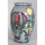 A small Moorcroft Balloons pattern vase of ovoid form decorated with tubelined balloons on a blue