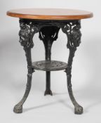 A cast iron pub table, the circular wooden top on a tripod cast-iron cabriole base,