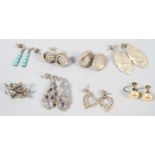 A collection of eight pairs of earrings of variable designs. Some are marked for silver.