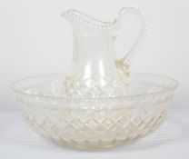 A Victorian cut glass water jug and basin, cut with diamonds, notches and lenses,