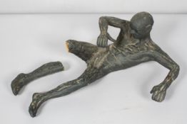 A composite sculpture of a man, modelled nude in an abstract dancing position, coloured in black,