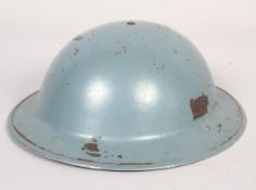 A Brodie steel Civil Defence helmet, with leather lining and canvas strap,