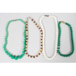 A collection of four beaded necklaces of variable designs together with an unstrung beaded necklace.