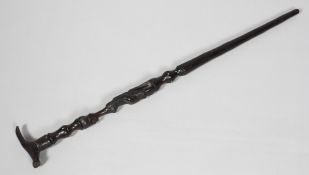 A 20th century African walking stick, the shaft carved with a seated figure with bone inlay,
