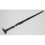 A 20th century African walking stick, the shaft carved with a seated figure with bone inlay,