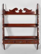 A Victorian mahogany three tier hanging shelf with pierced Gothic fretwork side panels