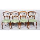 A set of four Victorian walnut balloon back dining chairs, mid 19th century,