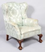 A George II wing back armchair, with arched top rail,