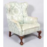 A George II wing back armchair, with arched top rail,