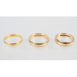 A collection of three wedding rings; Two hallmarked 9ct gold, One hallmarked 22ct gold.