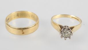 A yellow and white metal single stone ring set with a round brilliant cut diamond