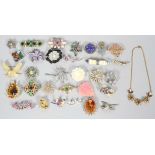 A collection of 31 costume jewellery brooches and a necklace, 20th century,
