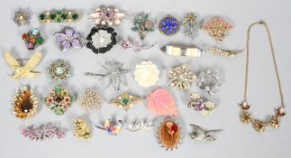 A collection of 31 costume jewellery brooches and a necklace, 20th century,