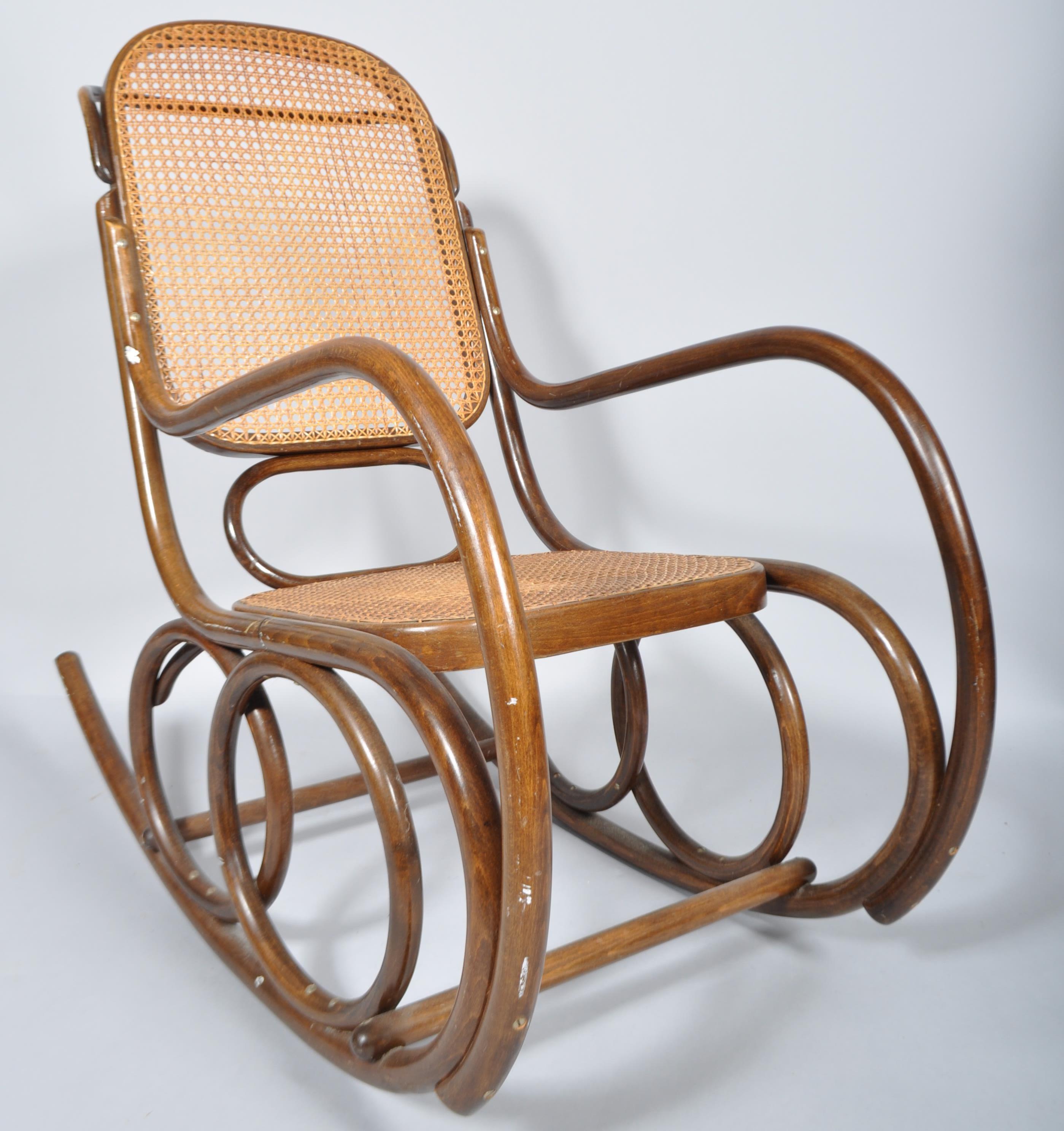 An early 20th Century Thonet style Czech bentwood rocker armchair having canework backrest and seat