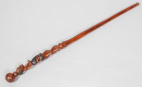 A 20th century African walking cane, the body carved with a kneeling figure, probably West African,