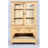 A Victorian pine kitchen dresser, the double glazed doors enclosing two adjustable shelves,