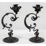 A pair of Art nouveau wrought steel and brass candlesticks, of foliate scrolled form,
