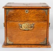 A Victorian oak tobacco cabinet, mounted with brass trefoil corner bracket, escutcheons and handles,