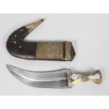 A Middle Eastern Jambiya knife with horn grip, in scabbard, with white metal mounts,