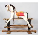 An early 20th century Galloper rocking horse, the horse with dappled grey body, glass eyes,