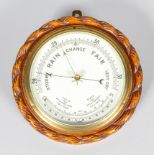 An early 20th century oak cased barometer, with white enamelled dial,