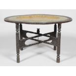 A Benares table, the oval brass embossed tray within hardwood mount on folding stand,