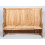 A large Victorian pine hallway settle with high panelled back and scroll arms,