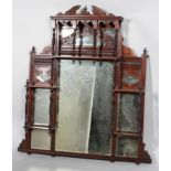 A late Victorian carved mahogany mirrored shelf,