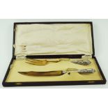 A Sclingen gilded serving knife and fork, with embossed white metal handle,