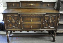 An oak sideboard with panel carved doors 96 cm high 153 cm wide
